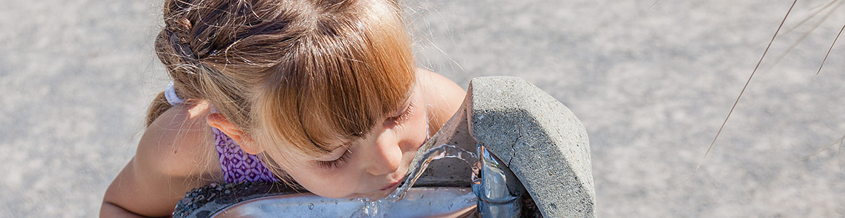 girl drinking clean water from a fountain
