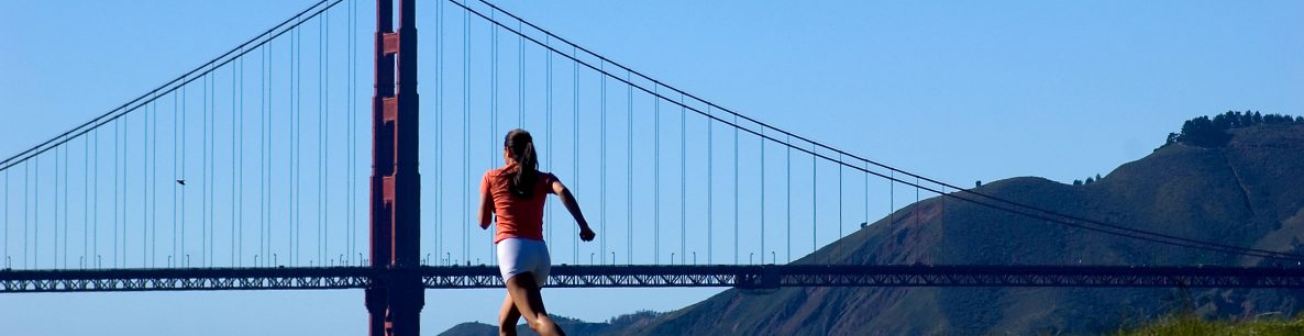 woman running near Golden Gate Bridge